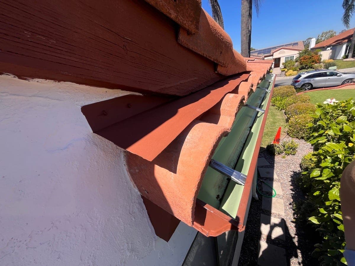 6-inch gutter upgrade with hidden mounts along a tile roof edge